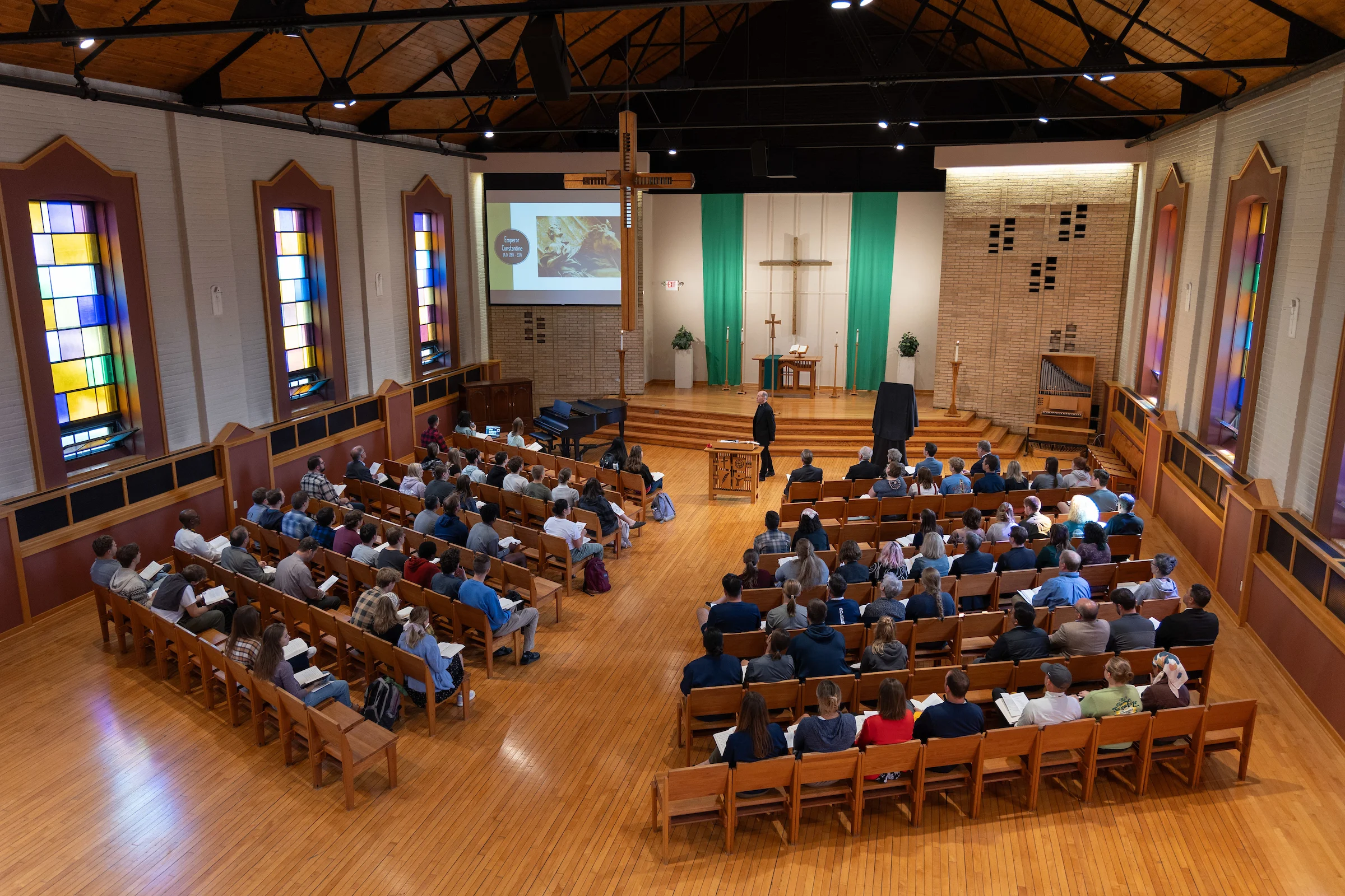 Wide shot from above of a chapel full of people