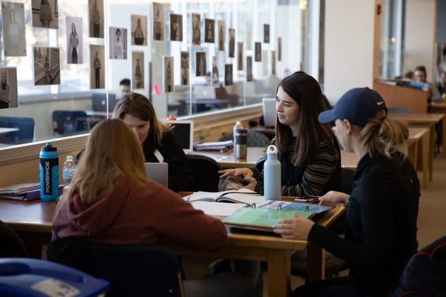 Group of students working at the library