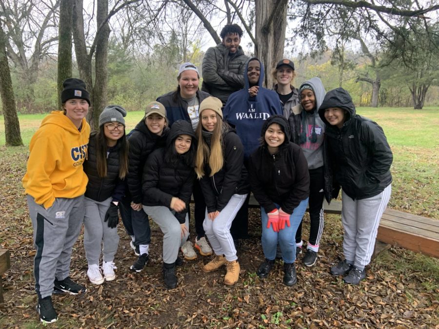 Group of CSP Students smiling at the camera outside at a park.