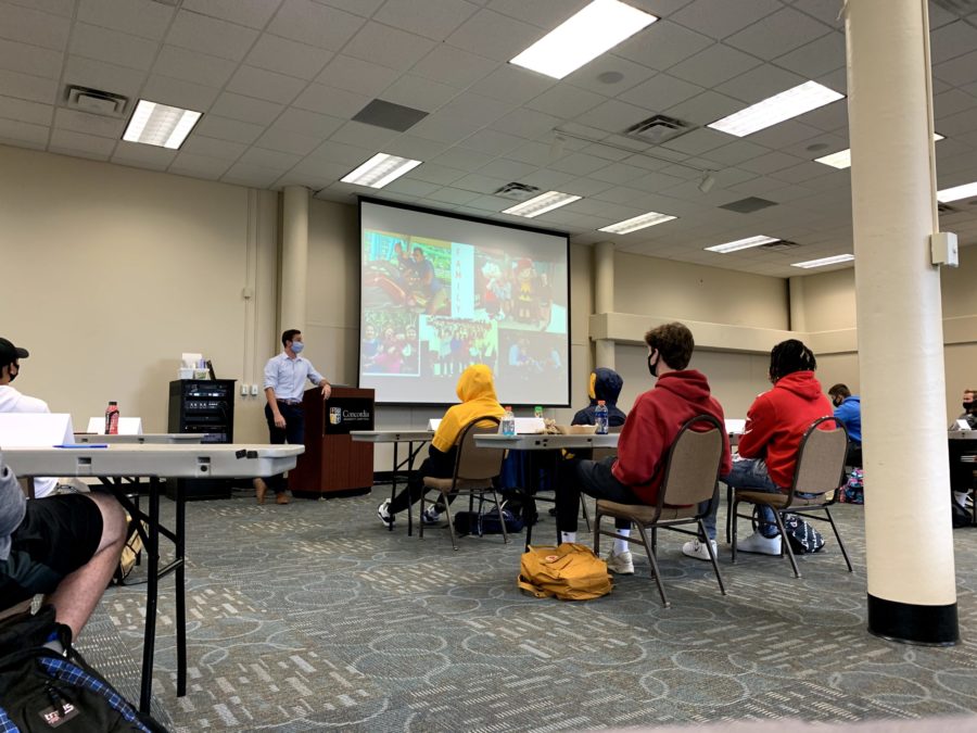 Business Leadership Community gathering in the BEC while hearing a presentation.