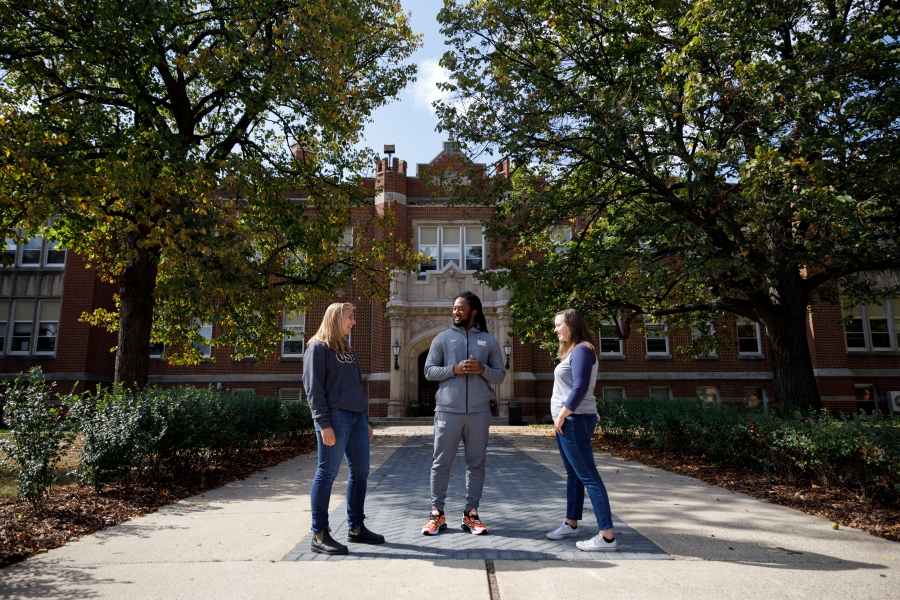 Three CSP students having a conversation outside of Meyer Hall