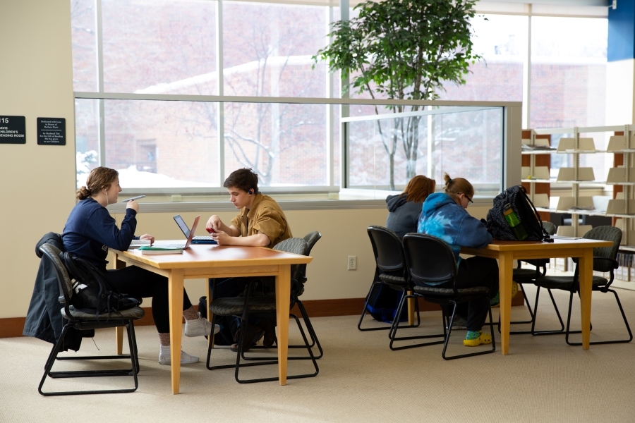 CSP Students working at tables in the library.
