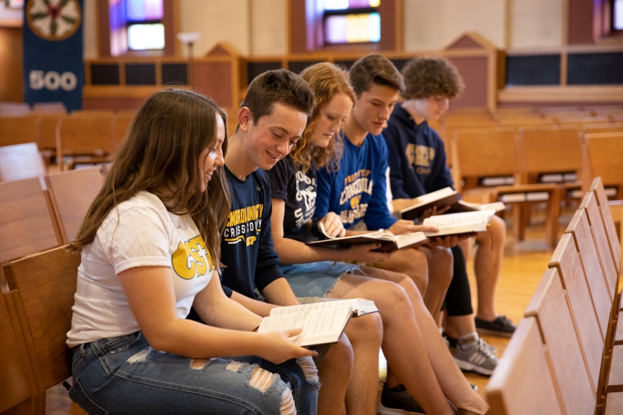 Group of CSP Students reading sheet music in the chapel.