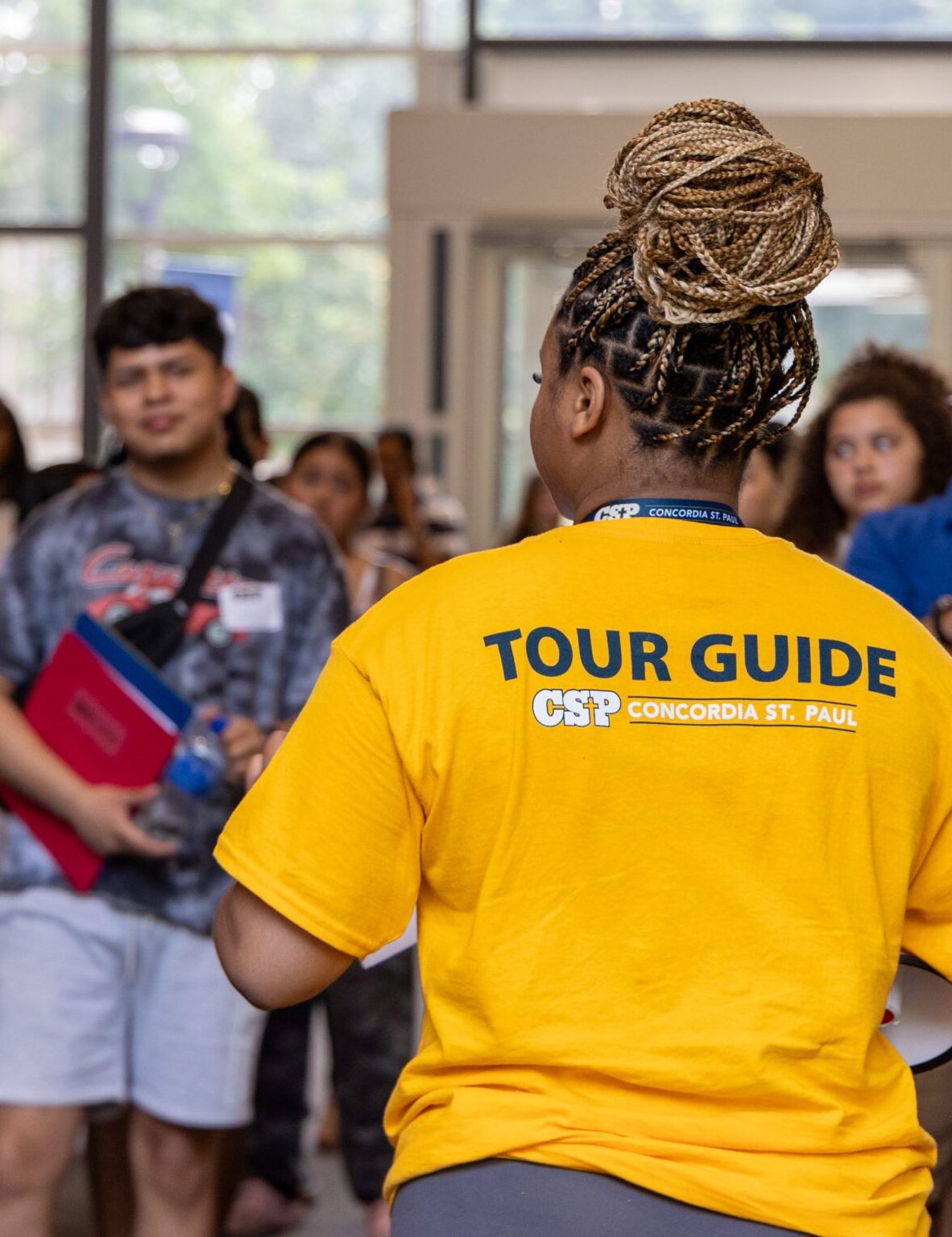 College tour guide giving a tour of campus to a group of students.