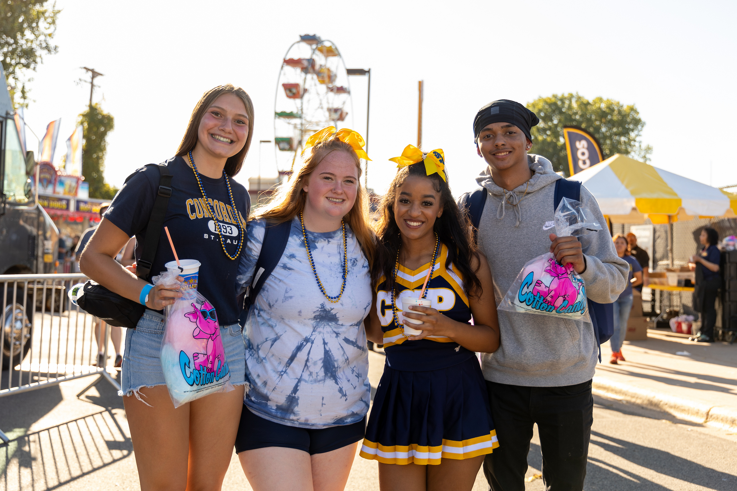 Group of four students at the homecoming carnival.