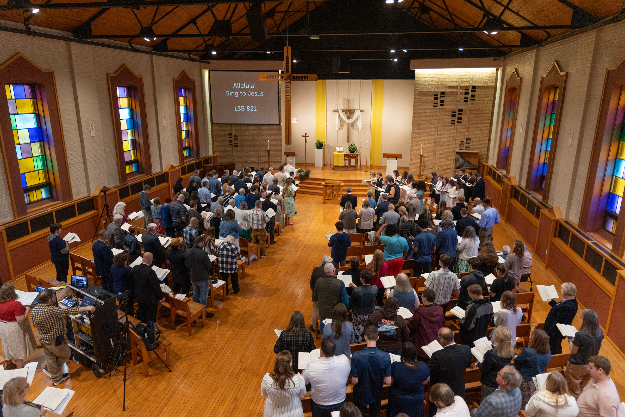 Chapel full of worshipers indoors.