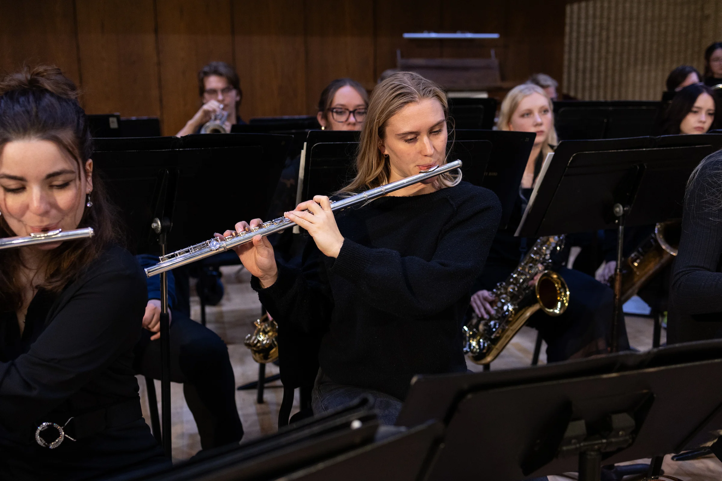 CSP band students playing the flute and other various instruments during a dress rehearsal performance.