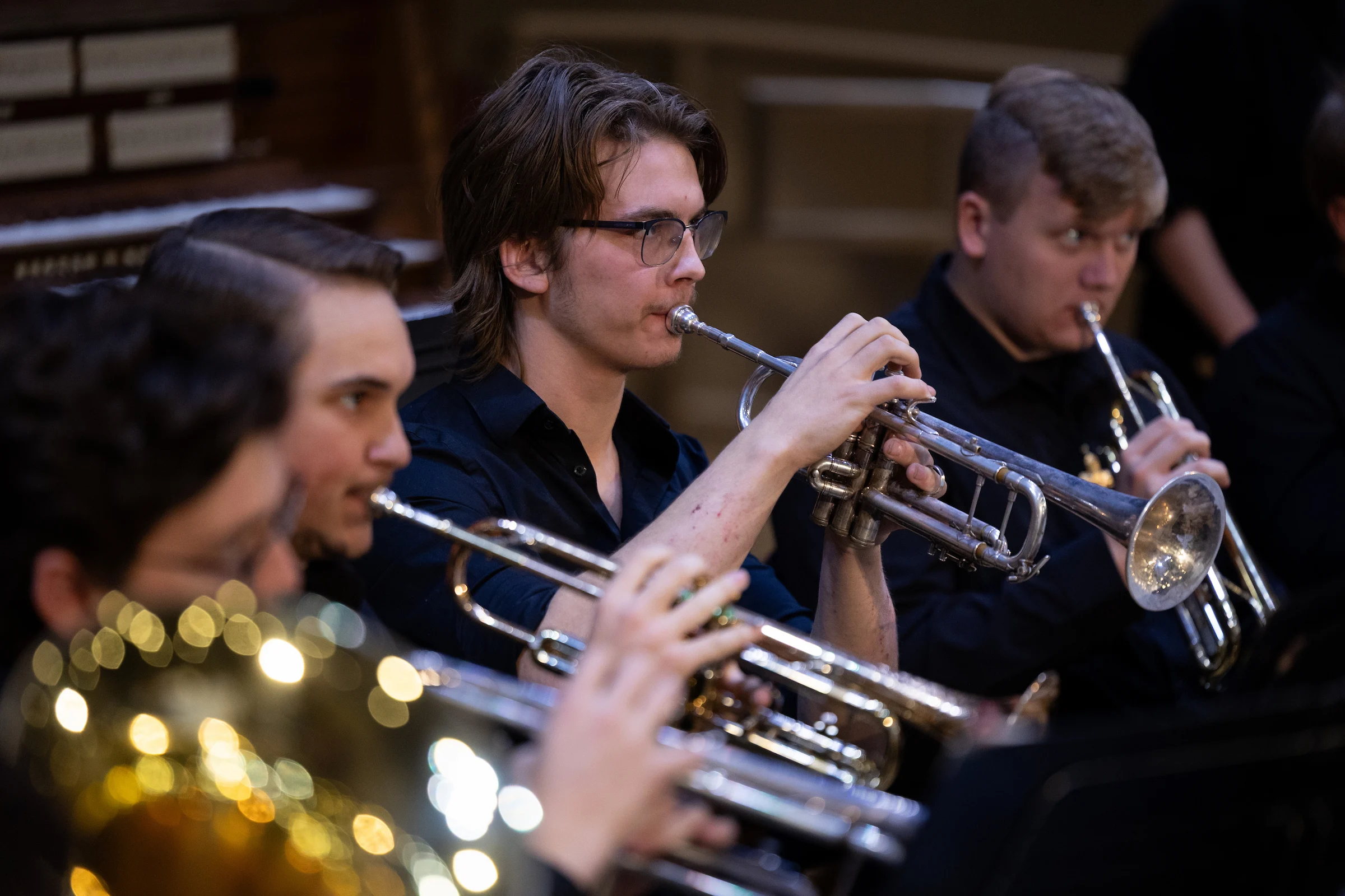 Group of CSP students playing horns and other instruments during a dress rehearsal performance.