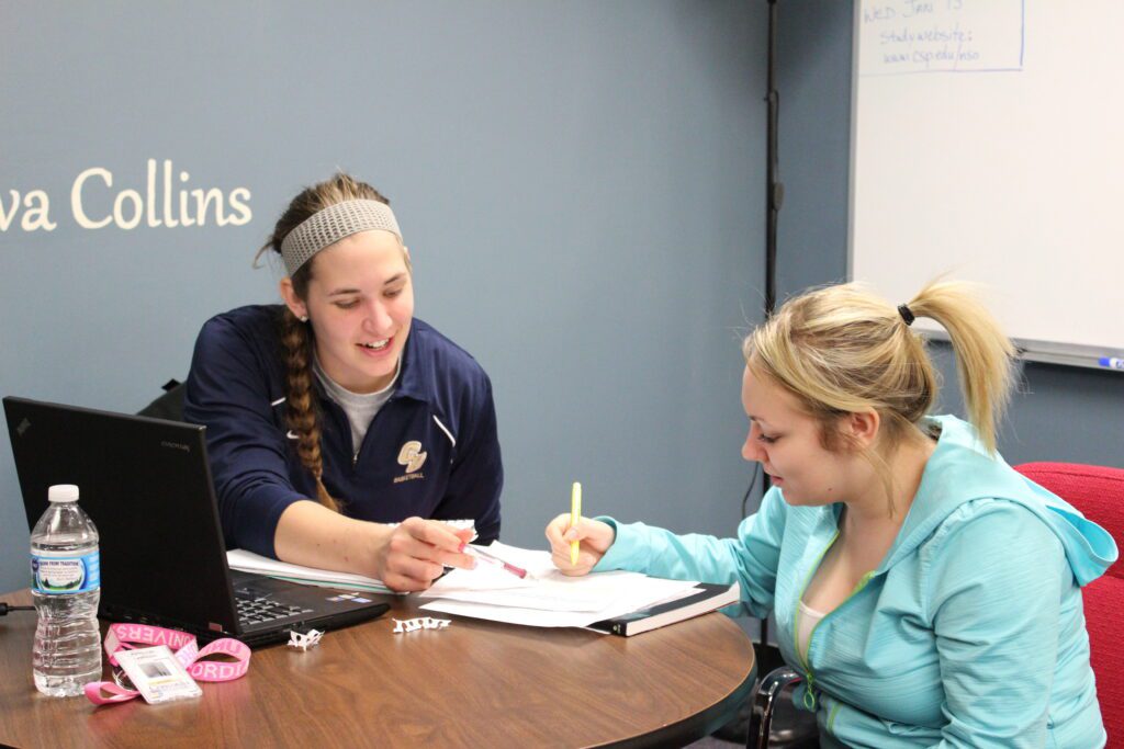 Two CSP students meeting at a table and studying.